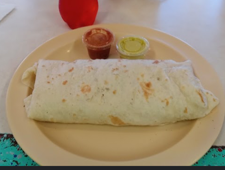 Flour tortilla burrito with red and green salsa on the side