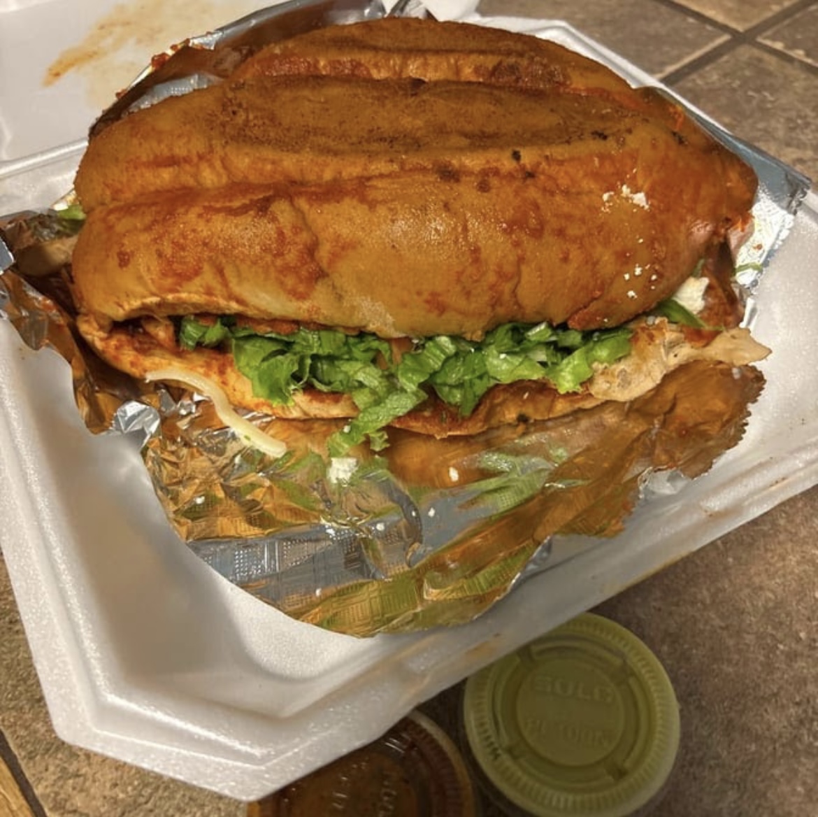 Panbazo torta dipped in chile rojo with lettuce and meat